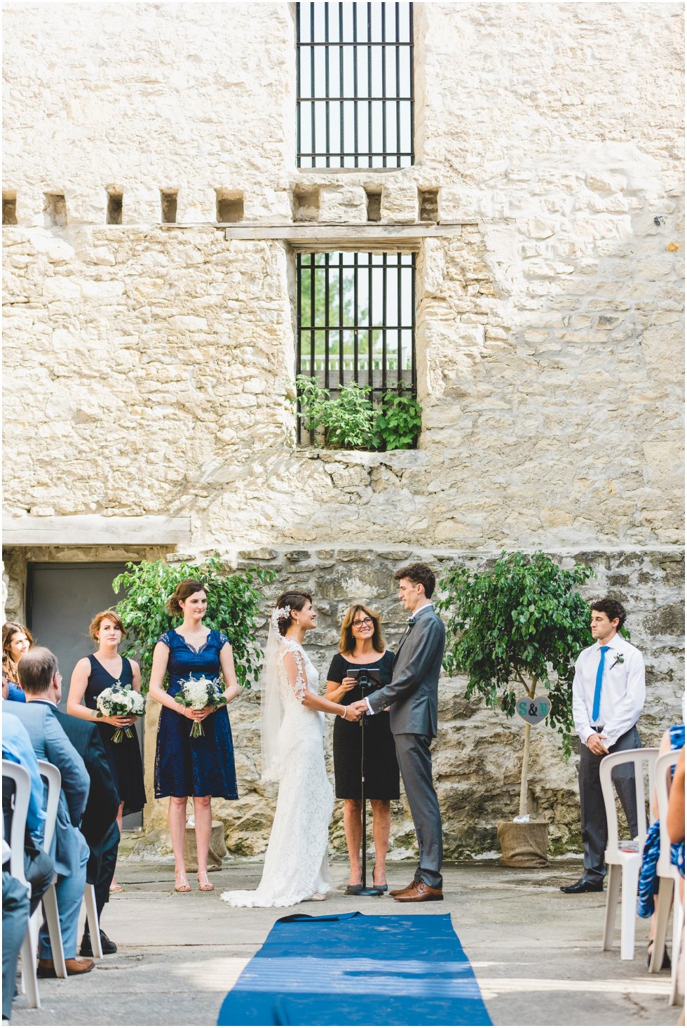 Bride and Groom saying vows during their Goldie Mill Ruins wedding ceremony