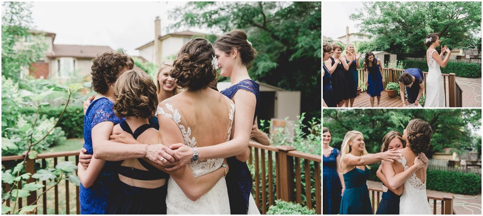 The bridal party hugging after seeing the bride