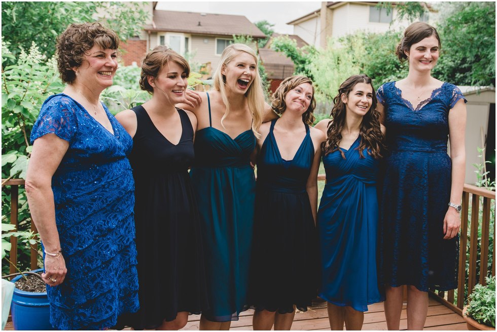 The bridal party smiling at the bride as they see her for the first time