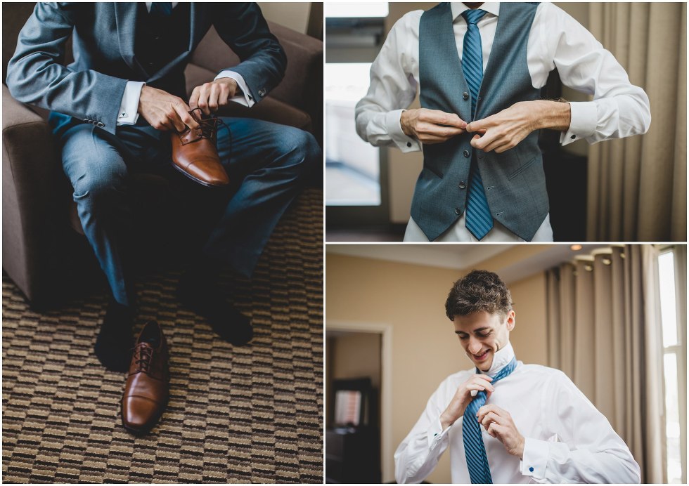 Groom getting ready by tying his tie and shoes 