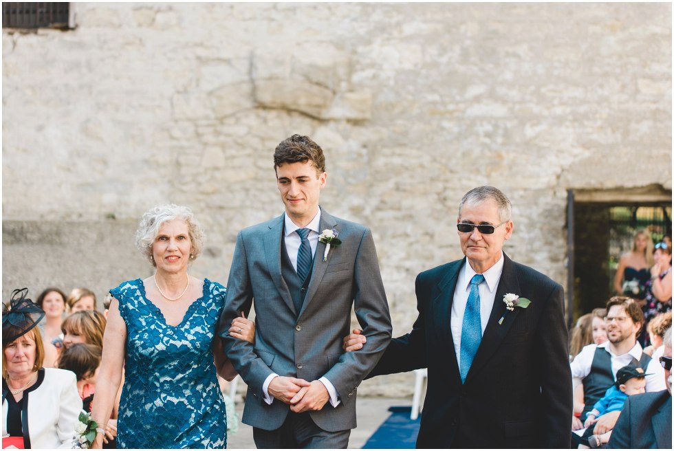 Grooms parents walking him down the isle during their Goldie Mill Ruins ceremony