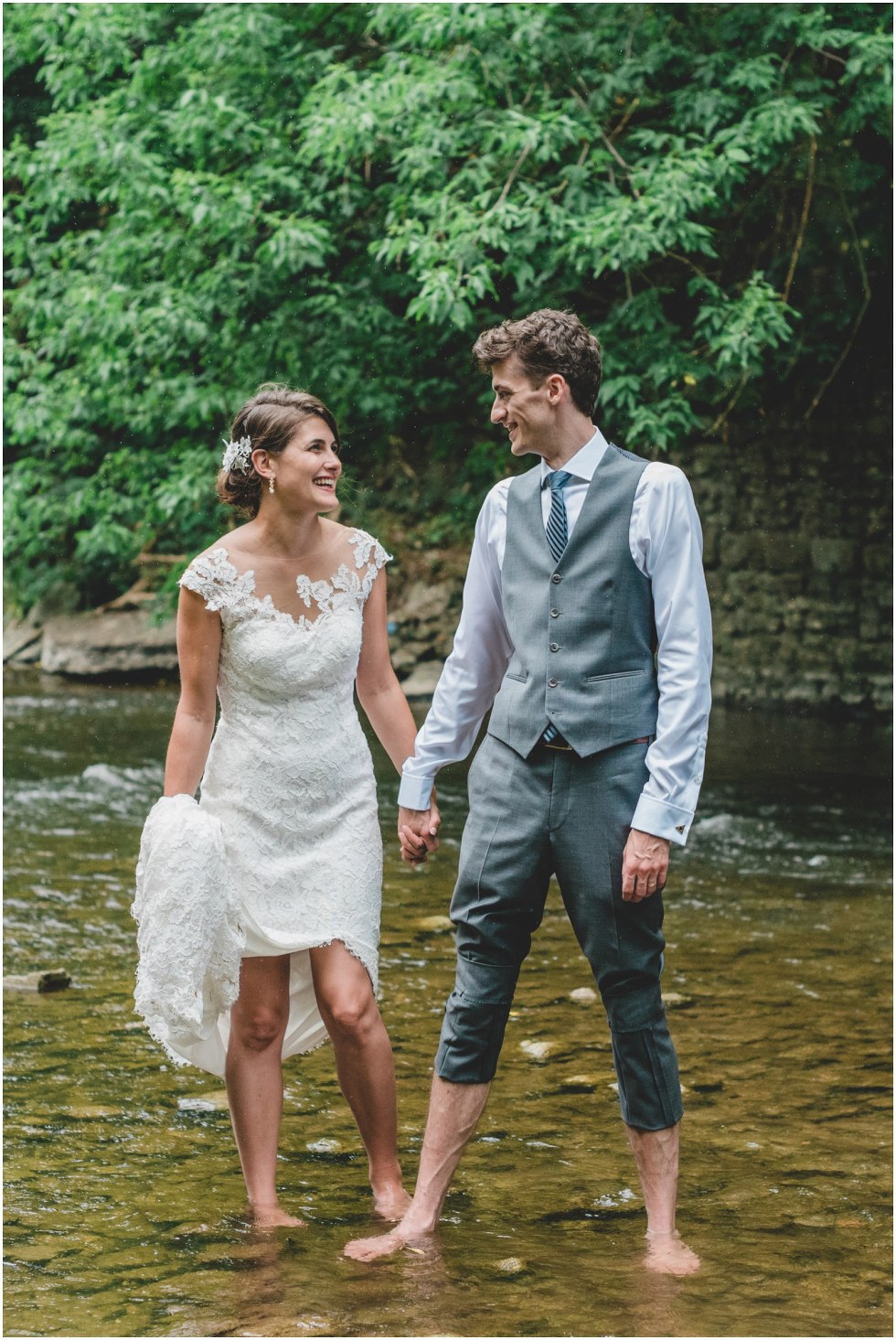 Bride and Groom laughing and smiling in the rain during their Goldie Mills Ruins wedding