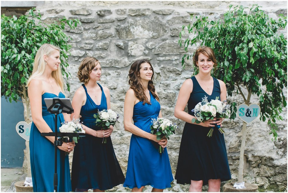Bridesmaids smiling during the Goldie Mill Ruins wedding ceremony
