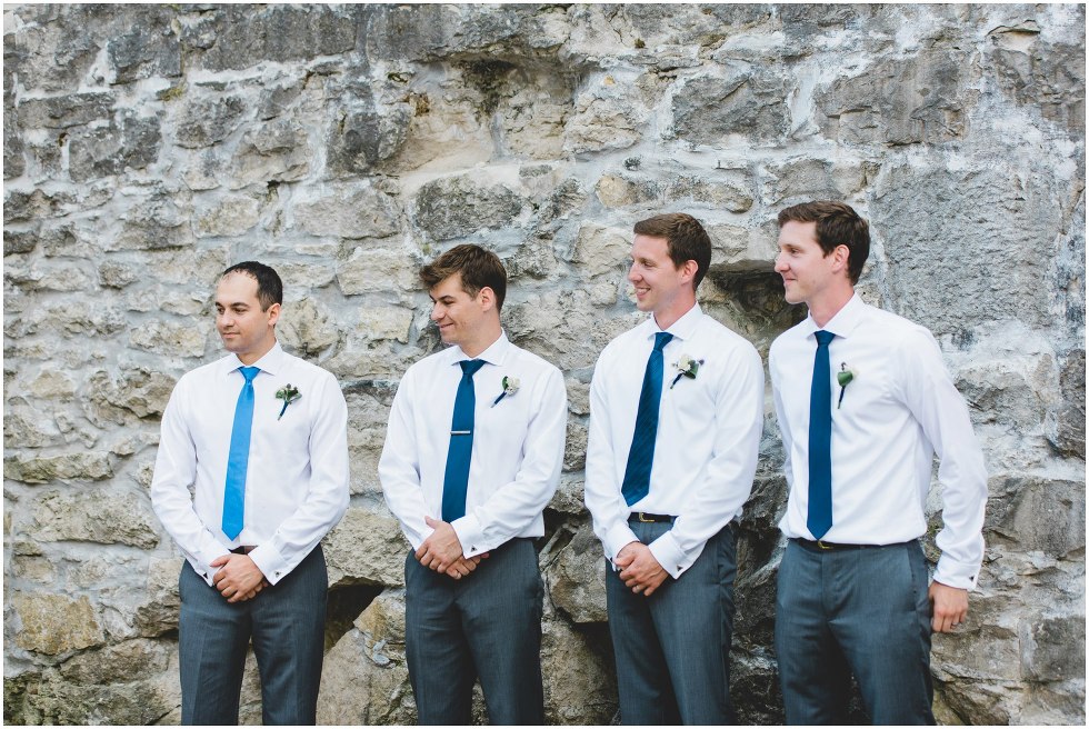 Groomsmen smiling during the Goldie Mill Ruins wedding ceremony