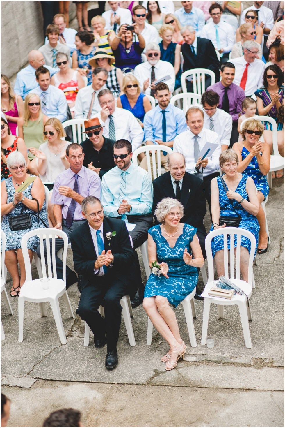 Guests smiling and clapping during the Goldie Mill Ruins wedding ceremony