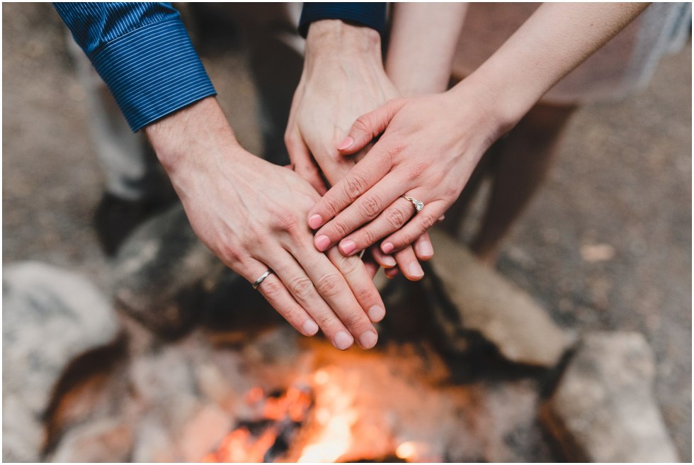 Couple warming hands over the fire