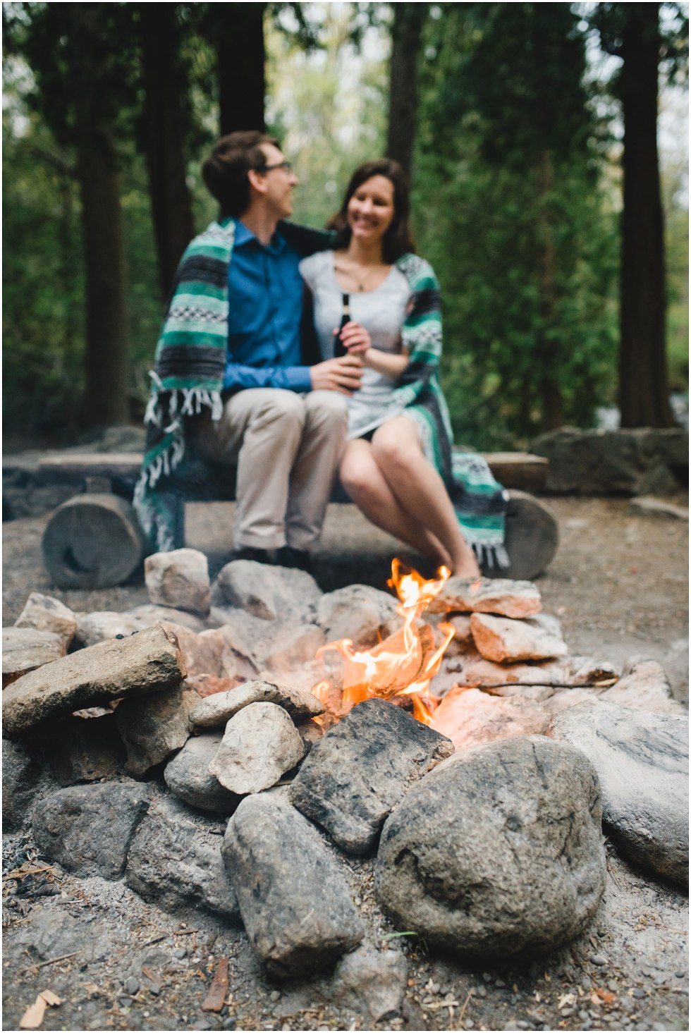 Couple sitting by the fire for their Hilton Falls engagement photos