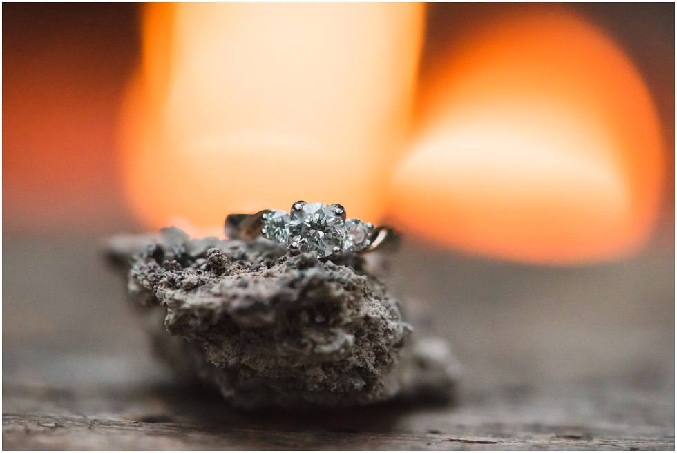 Engagement ring set on a rock by the fire