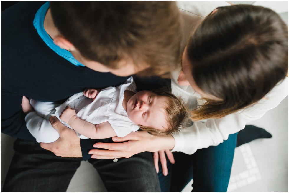 Parents holding their daugther during their Toronto Newborn Lifestyle photos