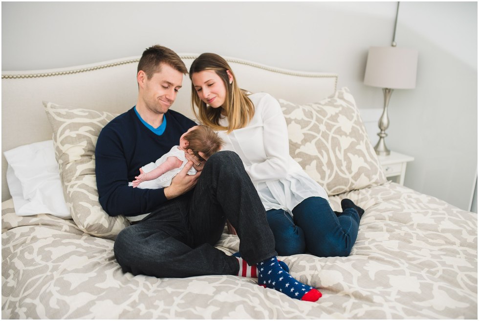 Parents holding their baby lovingly during their Toronto Newborn Lifestyle photos