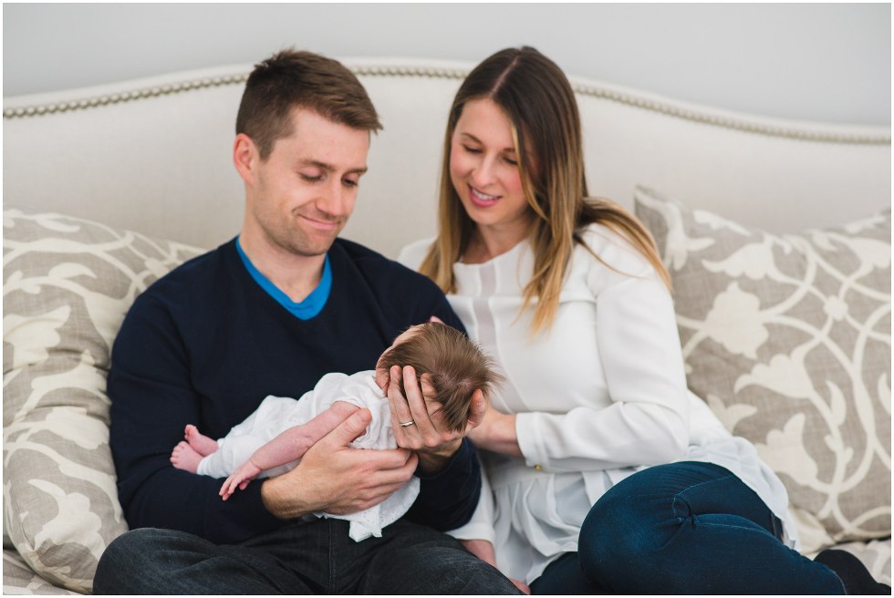 Parents looking and smiling at their daughter during their Toronto Newborn Lifestyle photos