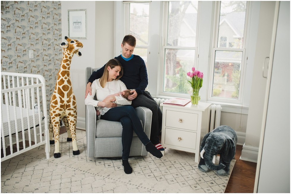 Parents holding their daughter during their Toronto Newborn Lifestyle photos