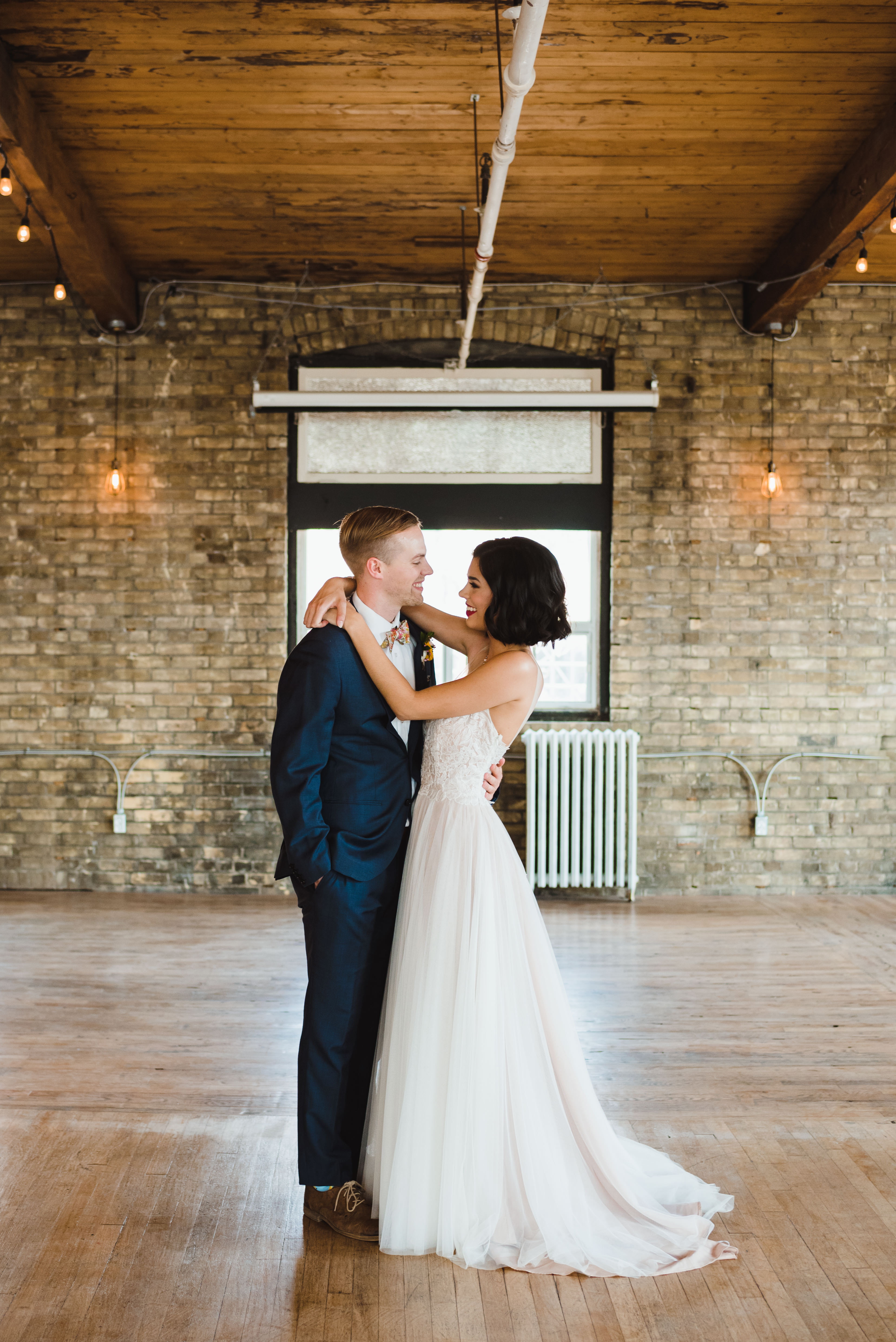 bride and groom slow dancing inside old brick building Toronto wedding photography