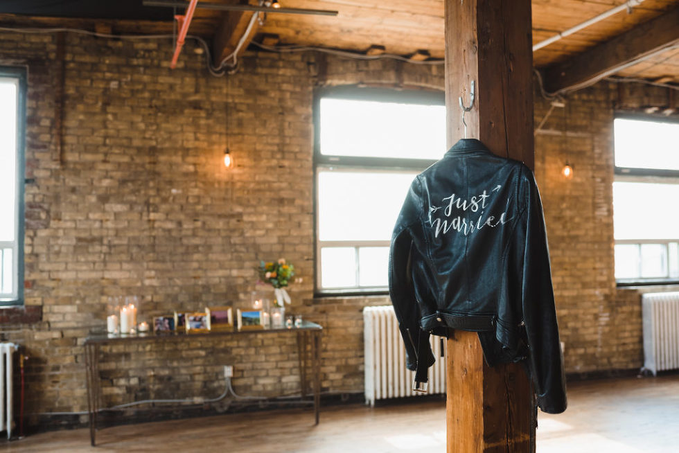 just married leather jacket hanging on wooden post at the Jam Factory Toronto wedding photography
