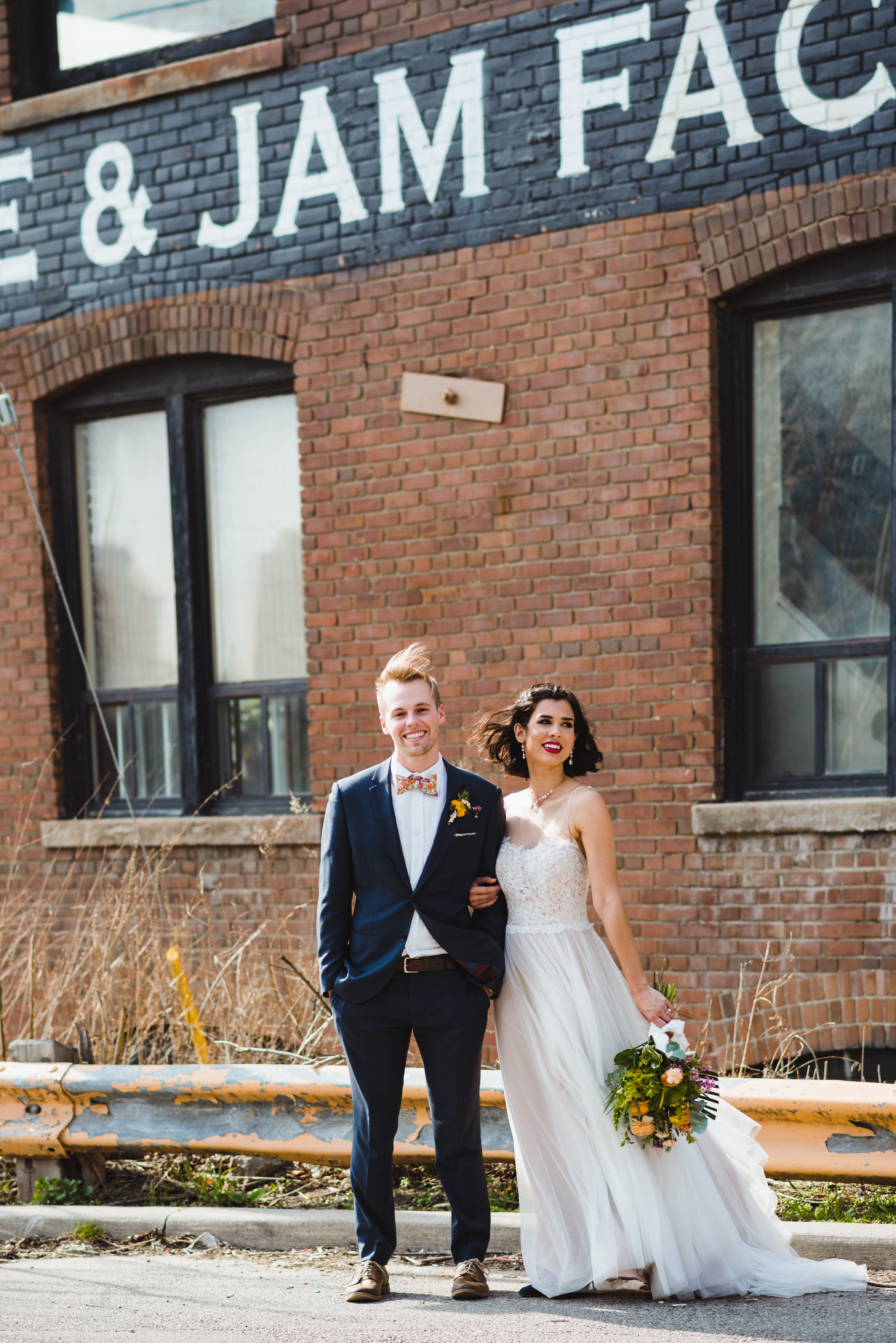 bride and groom linked arms outside the Jam Factory Toronto wedding photography