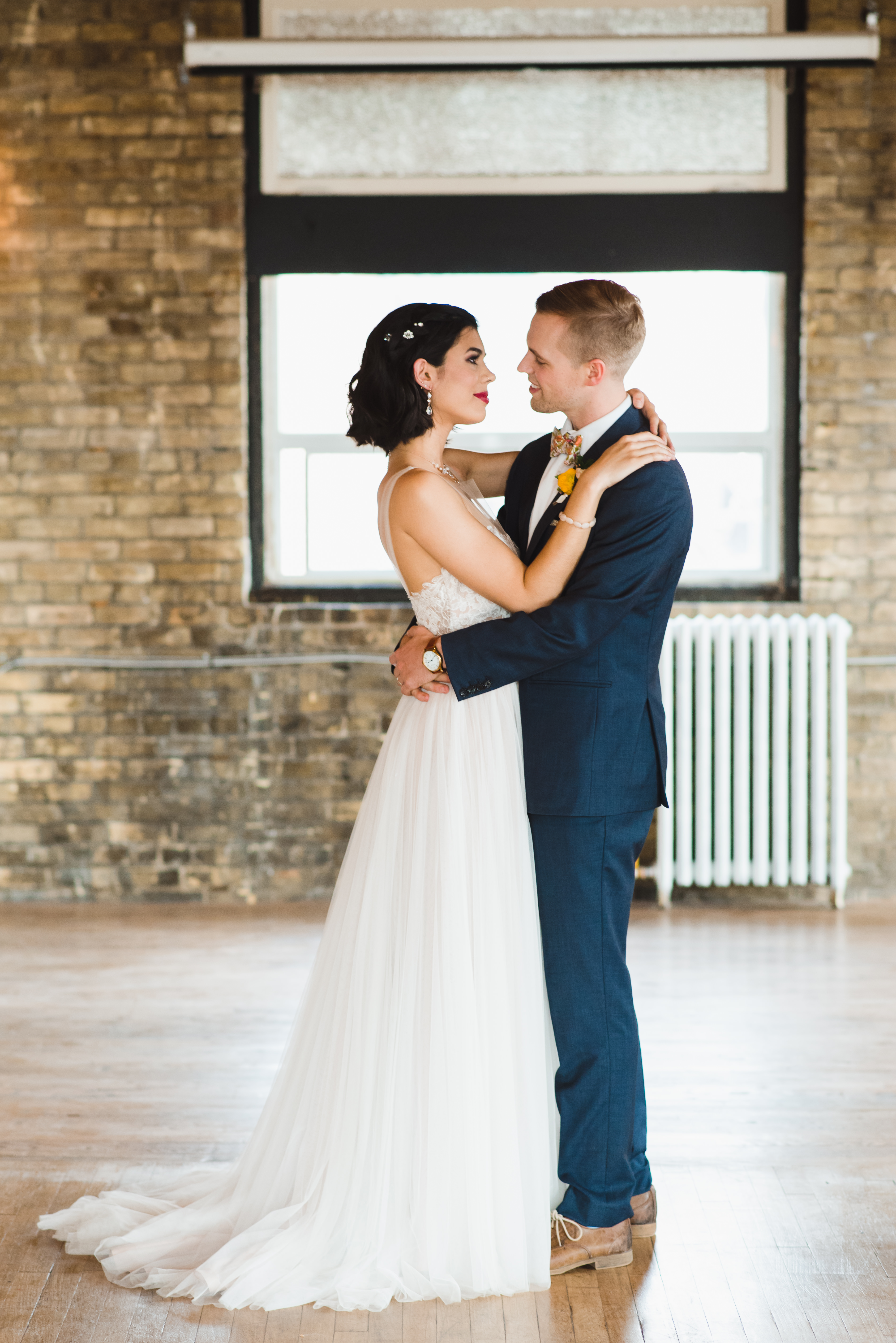 bride and groom in loving embrace at the Jam Factory Toronto wedding photographer Gillian Foster