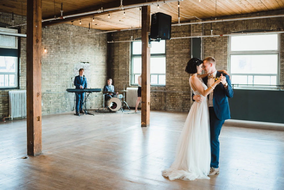 bride and groom dancing with 3 piece wedding band in the background at the Jam Factory Toronto wedding photography