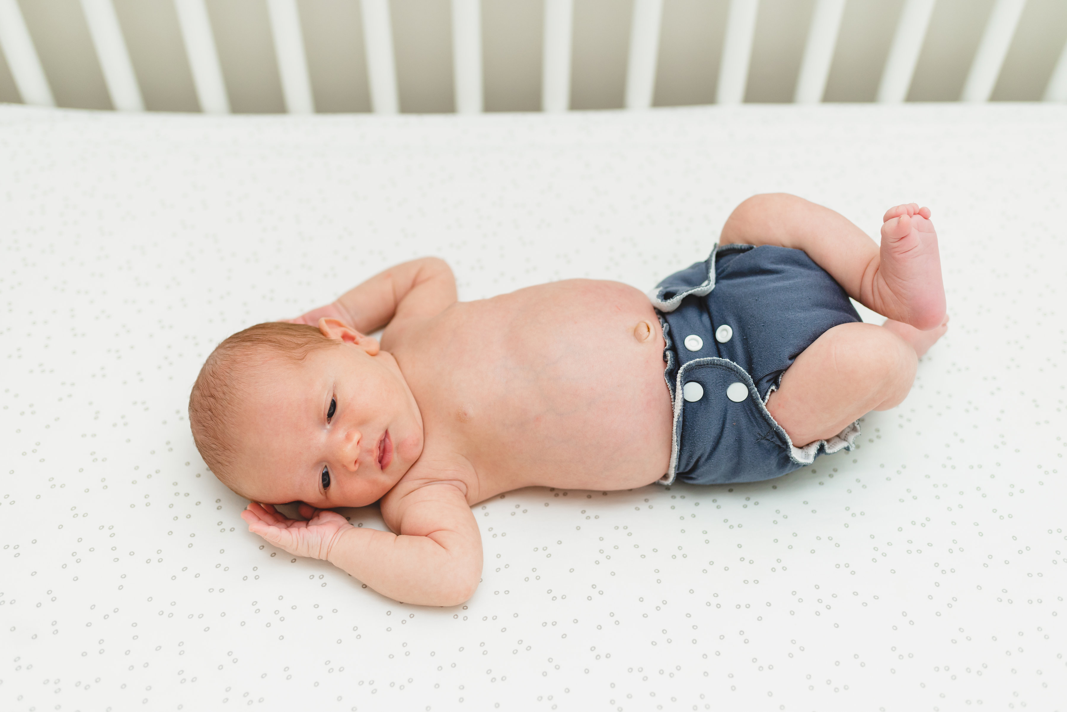 newborn in white crib Gillian Foster Photography